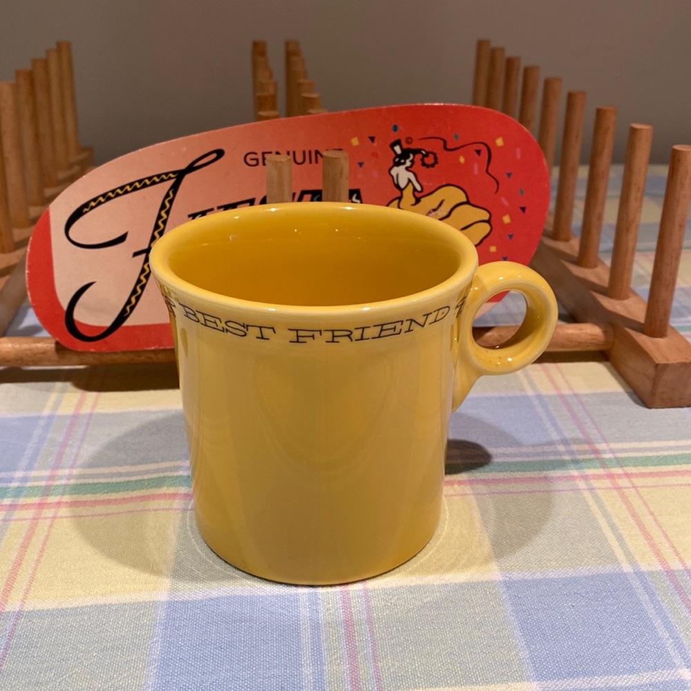 Fiestaware yellow mug with “Best Friend” around top with dogs and dog bone